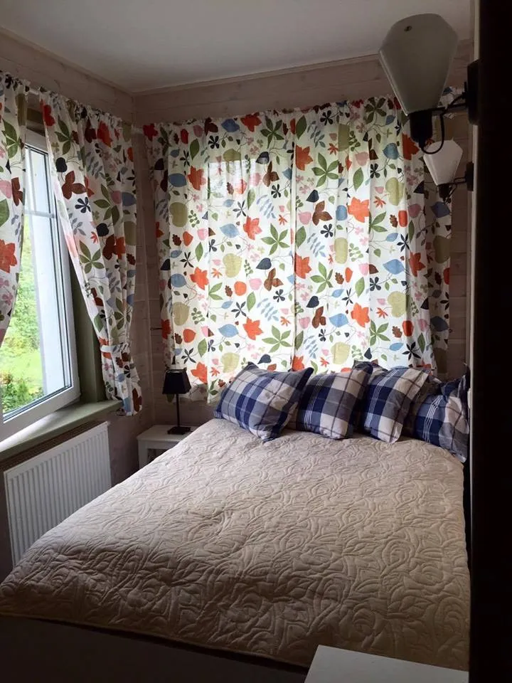 A bright bedroom with pine-clad walls
